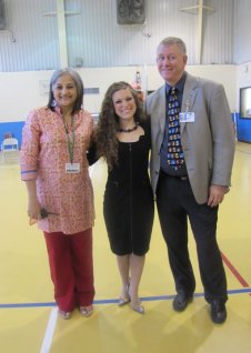 Victoria stands with two Gould Elementary School administrators.