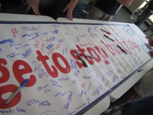 Students at Hilton Head High School sign an "I pledge to stop bullying" sign. 
